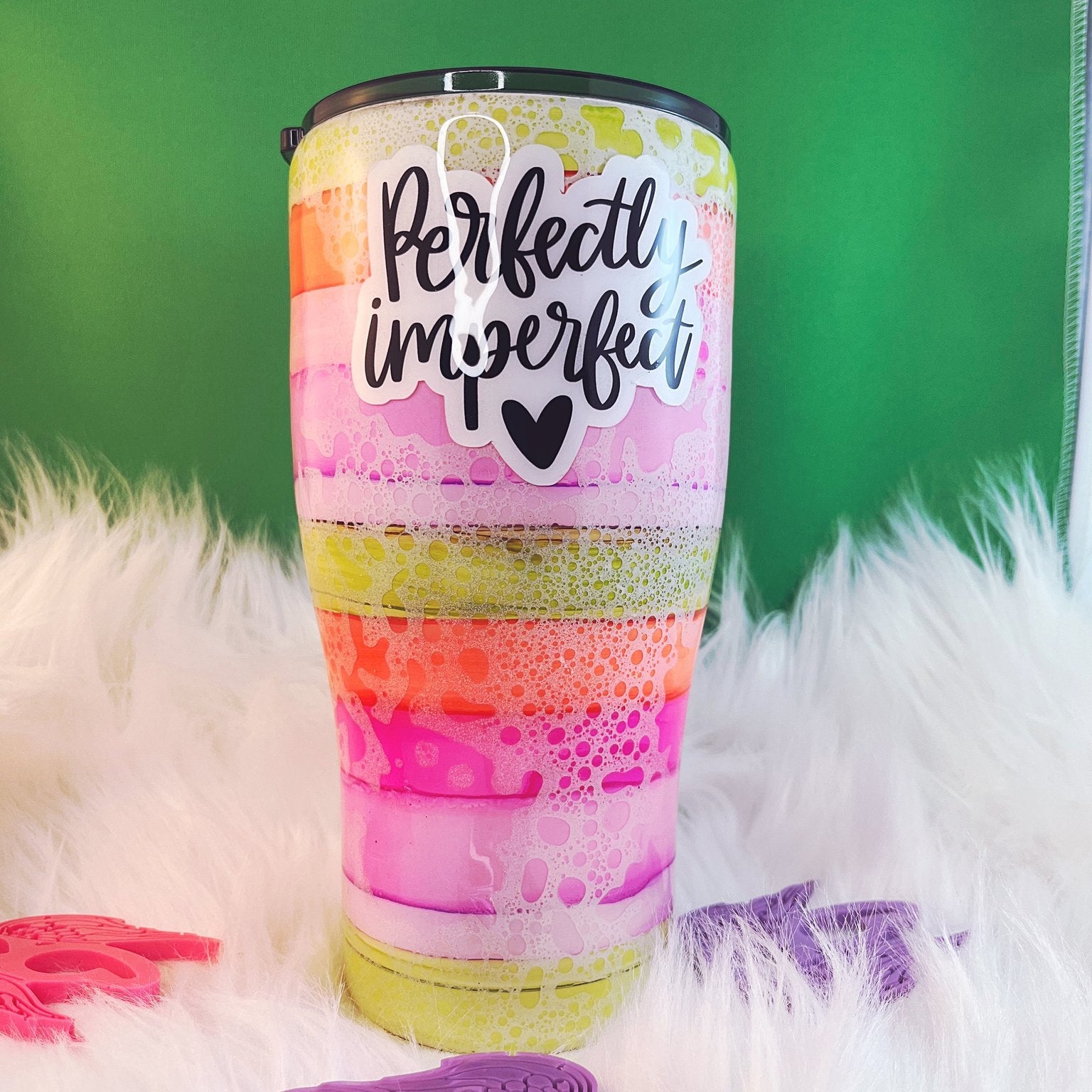 Colorful tumbler with 'Perfectly Imperfect' text on a green background