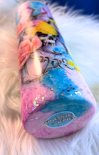 Colorful 30 oz custom tumbler with floral and skull design on a fluffy white surface